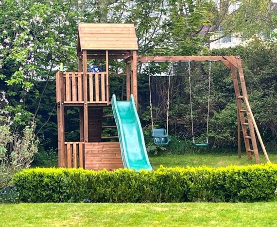 tall climbing frame with Monkey Bars. x2 swings and slide